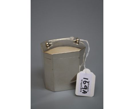 An Edwardian tea caddy, elongated octagonal, the hinged cover with swing handle, gilt interior, London 1907, 8cm high, 4oz