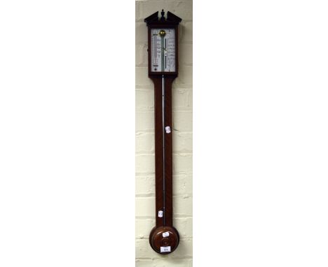 A 20th century mahogany stick barometer, the urn and broken architectural pediment over silvered gauge, 92cm