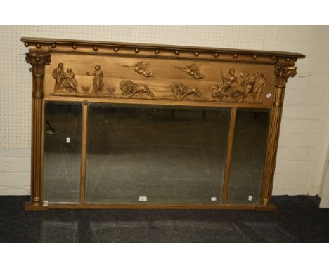 An early 19th century gilt gesso wall mirror, the inverted breakfront pediment with ball slip over a shallow relief classical