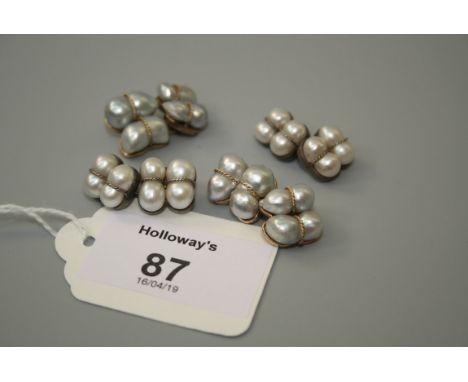A pair of cultured pearl cufflinks, two baroque pearls to each plaque with ropetwist detail, to 4 yellow metal mounts and ano