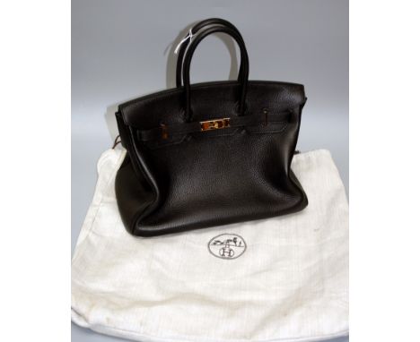 An 'as new' Hermes type black leather Birkin type tote bag with gilt metal clasps, padlocks and drawstring outer sleeve