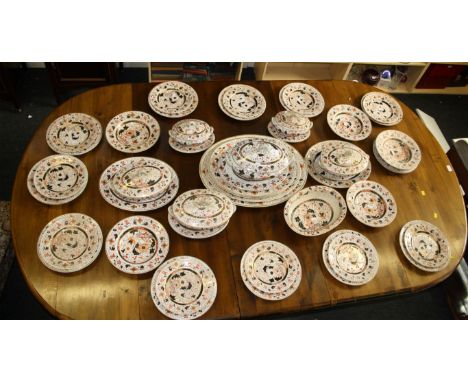 An extensive Victorian ironstone dinner service, comprising soup, sauce and vegetable tureens and stands, four oval meat plat