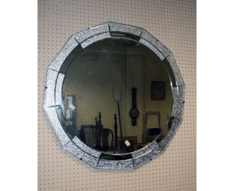 A 1930's Art Deco wall mirror with central circular plate and twelve peripheral clear/ frosted plates, 70cm diameter