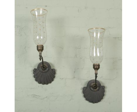 A pair of wooden and brass mounted wall mounted sconces, formed as shells featuring gilt decorated glass shades. Height: 29cm