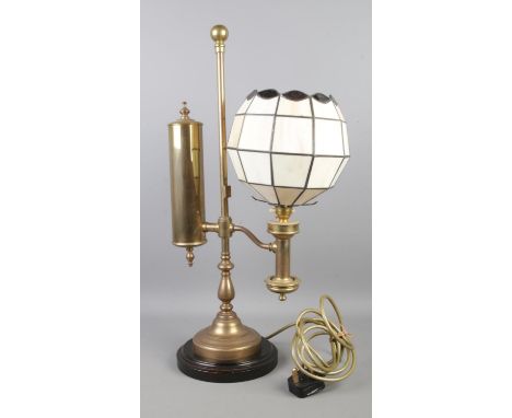 An early 20th century brass on wooden base gas table lamp converted to electricity.
