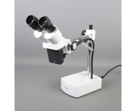 An Amscope binocular 10X-20X stereo microscope on boom-arm with light. Comes with original box and accessories