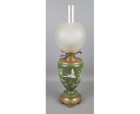 A Victorian Duplex brass and ceramic oil lamp featuring painted bird amongst bamboo and frosted shade. Height 58cm.