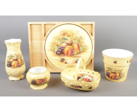 Five pieces of Aynsley ceramics, in the Orchard Gold design. To include plaque in surround, basket, vase and tapered pot.