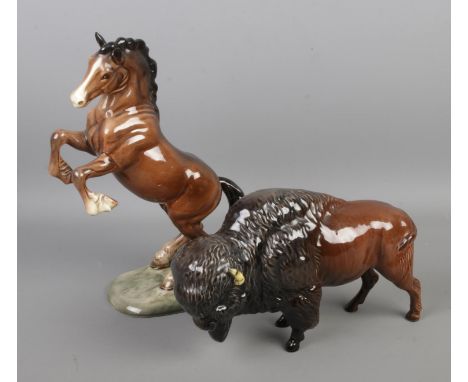 Two Beswick ceramic figures to include Bison model 1019 and rearing Welsh Cob horse model 1014.  Bison has one damaged horn.