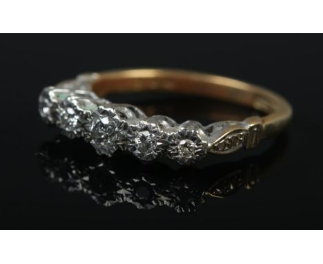 An 18ct gold and platinum five stone diamond ring with illusion setting. Size M. 3.5g.