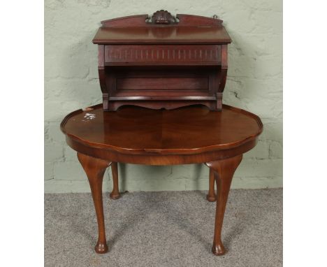 A small oval occasional table together with wall mounted shelf