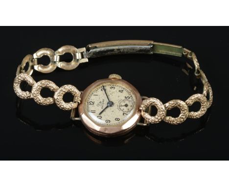 A ladies 9ct gold Record manual wristwatch on rolled gold bracelet strap.  Running.