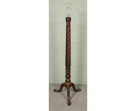 A carved mahogany standard lamp with ball and claw feet and twist carved column