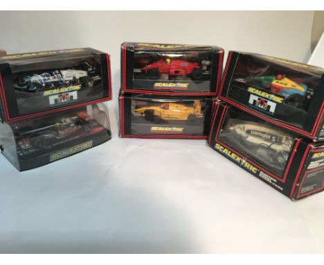 Selection of 6 boxed scalextric cars including a Lewis Hamilton f-1 car.