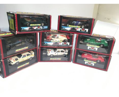 Selection of 8 boxed scalextric cars including 2 Aston martins.