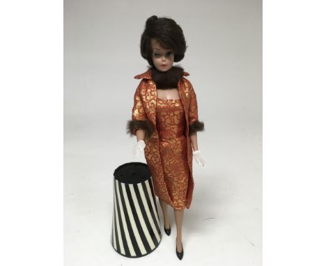 A vintage 1962 ‘bubblecut’ Barbie, straight legged with side parting, brunette hair, dressed in original labelled ‘Golden Ele
