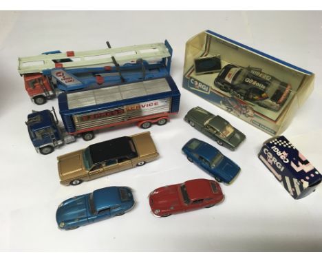 A collection of boxed /unboxed Corgi model vehicles including a boxed Ford Cosworth , a car transporter, a Lincoln Continenta