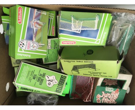 A box containing a large collection of Subbuteo items including pitches, goals, cups, spare players etc