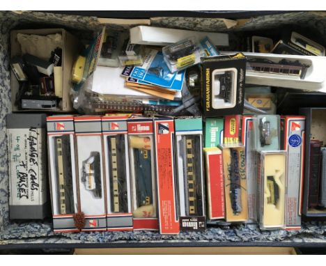 A suitcase containing a collection of boxed and inboxed " N " gauge model railway locomotives ,carriages , goods wagons etc i