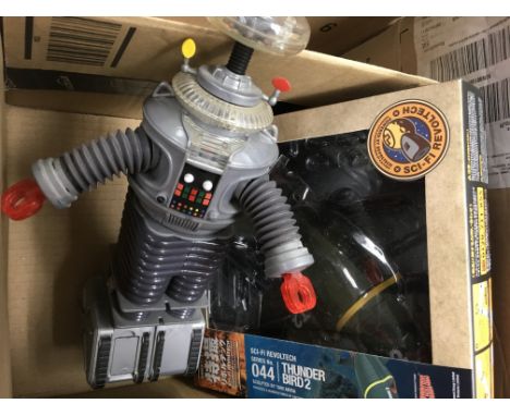 A boxed Thunderbird 2 by Kaiyodo and an unboxed Robbie The Robot