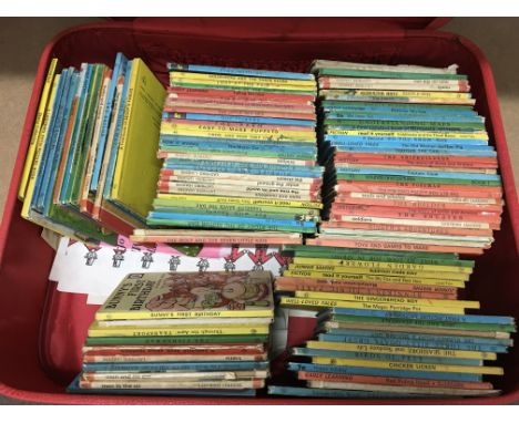 A suitcase containing various vintage Ladybird books.