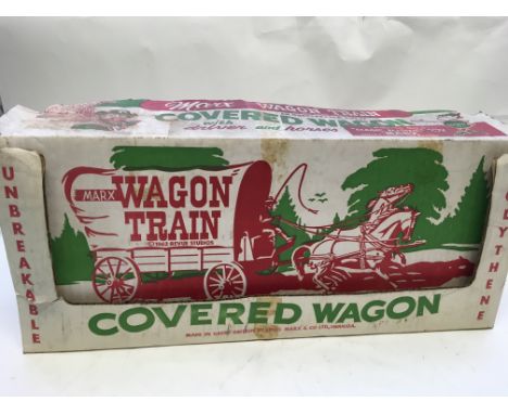 A boxed Official polythene Wagon Train covered Wagon by Marx, with driver and accessories.