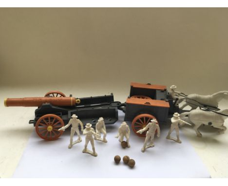A Tri-ang crane ,a plastic civil war US Army wagon and gun carriage ( maker unknown ) ,an " O " gauge Hornby station and sign