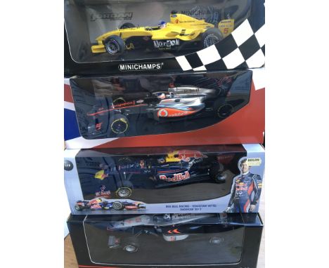 A collection of 4 boxed 1/18 scale racing cars by Minichamps including McLaren x 2 , Red Bull and Jordan .