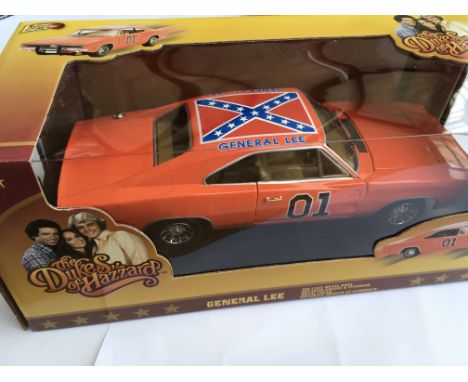 A boxed 1/18 scale Dukes of Hazard General Lee vehicle by Johnny Lightning together with a boxed Stingray security patrol veh