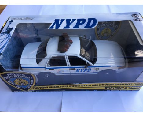 A boxed 1/18 scale New York police department patrol car with lights and sound by Greenlight together with a boxed Los Angele