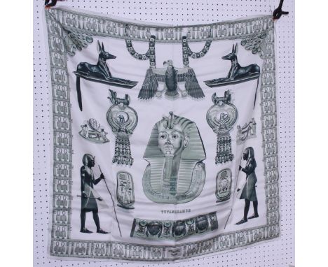 Two Hermes scarves, Tutankhamun, designed by Vladimir Rybaltchenko, in shades of green and cream, and a Christine Henry scarf