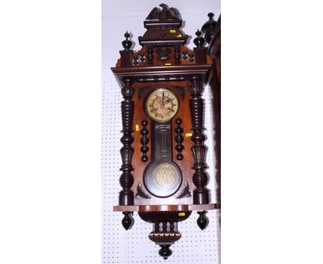 An American walnut cased wall clock with eagle finial, gilt dial and Roman numerals