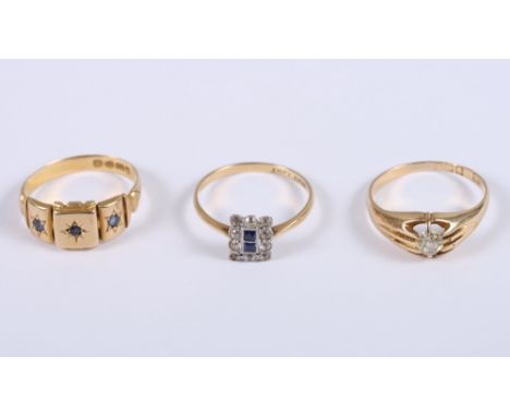 An 18ct gold and sapphire three-stone ring, size M, an Art Deco 18ct gold, diamond and sapphire plaque ring, size M, and an 1