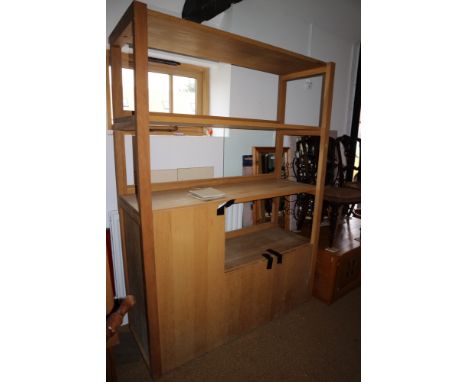 A light oak wall unit, fitted shelves over cupboards, 52" wide x 70 1/2" high