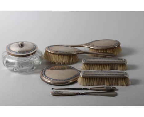 An eight-piece silver and enamel dressing table set, by William Hare Haseler