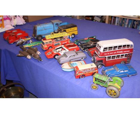 A collection of tin-plate toys, including cars, a fire engine, boats, busses, etc