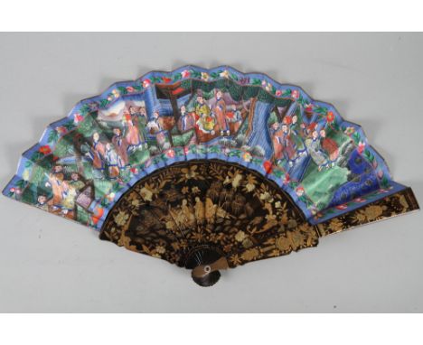 A 19th century Canton lacquered fan with hand-painted figure decorated vane, ivory faces and silk costumes, 18" wide