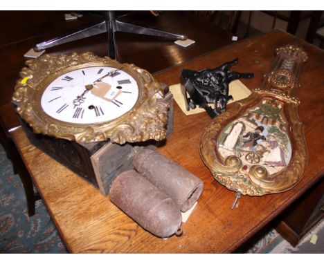 A gilt framed bracket clock with white enamel dial, Roman numerals and figure decorated pendulum, and black painted brackets