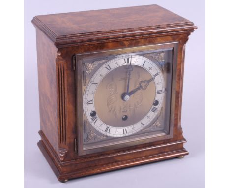 A walnut cased mantel clock by Elliot, retailed by Wilson & Gill with brass dial and silvered chapter ring, and a slate mante
