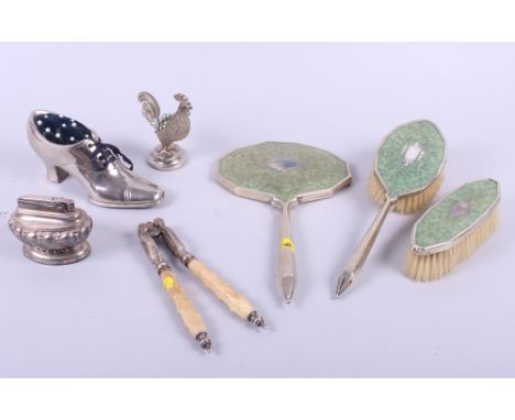 A silver plated pin cushion, in the form of a shoe, another in the form of a cockerel, a plated lighter, a nutcracker and a b