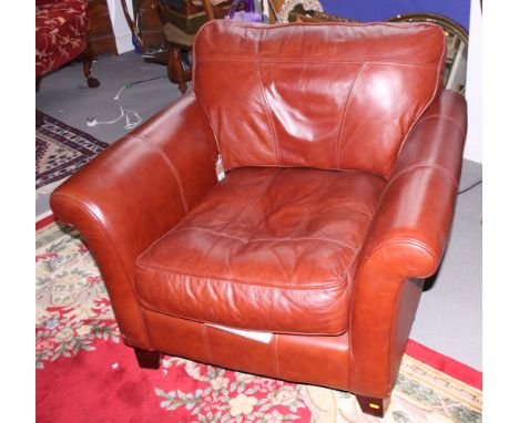 A modern leather deep seat armchair with loose cushion