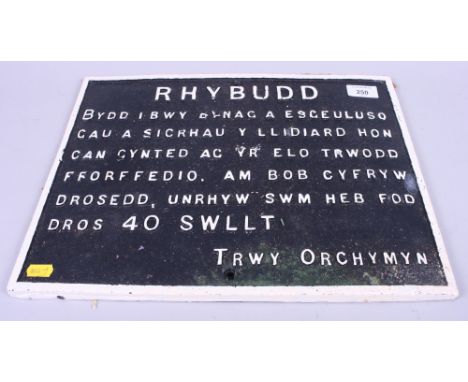A Welsh black and white painted gate warning sign