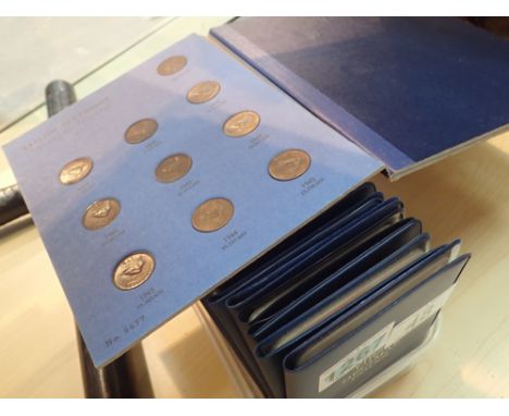 Quantity of Britians first decimal coin sets and a part filled Whitworth farthing book