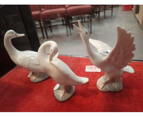 Two Lladro geese and a Nao example