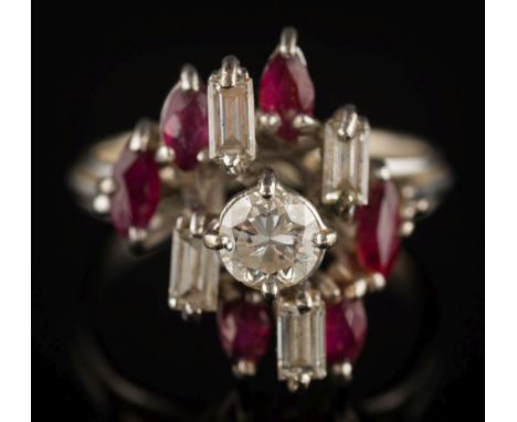 A diamond and ruby eleven-stone cluster ring: the central circular, brilliant-cut diamond approximately 0.35ct, within a surr