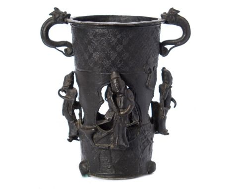 A Chinese bronze two-handled vase: of pierced tapering cylindrical form applied with chilong handles and four standing figure
