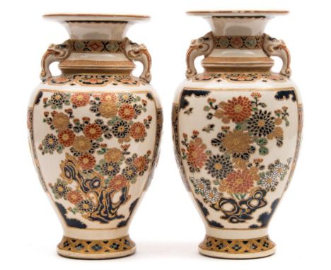 A pair of Japanese Satsuma vases: of baluster form with mythical beast mask handles, enamelled and gilded with panels of flow