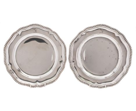 A pair of late Victorian silver dinner plates, maker R & S Garrard & Co, London, 1892: crested, of circular outline, with gad