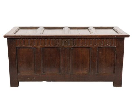 An early 18th Century oak rectangular coffer:, of moulded panel construction, having a hinged top, the front with a fluted fr