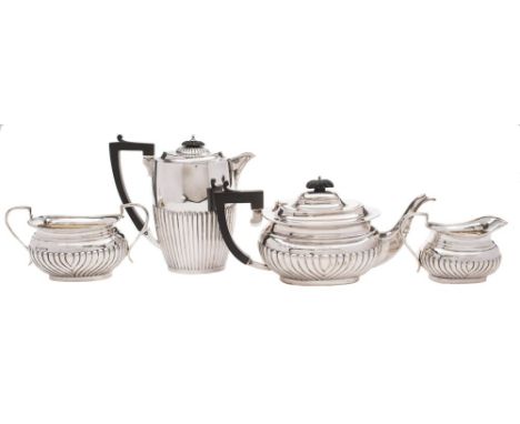 A matched George V silver three-piece tea service various makers and dates: inscribed, of barge-shaped outline, with half ree